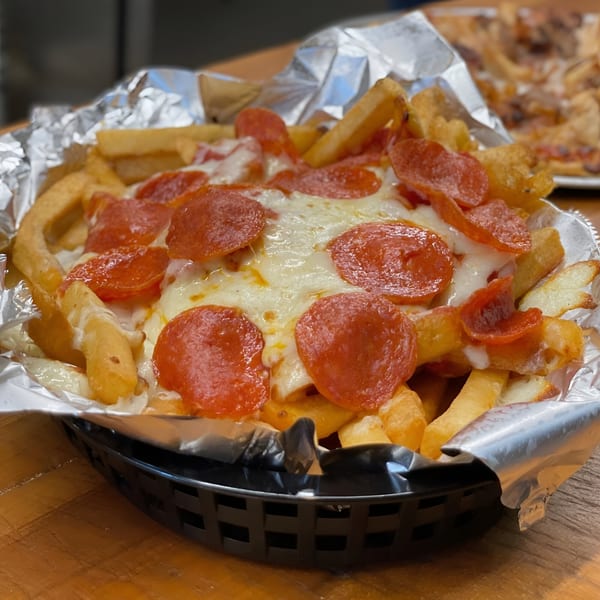 Pizza Chalet's pepperoni pizza fries, a basket of fries topped with melted cheese and pepperoni.